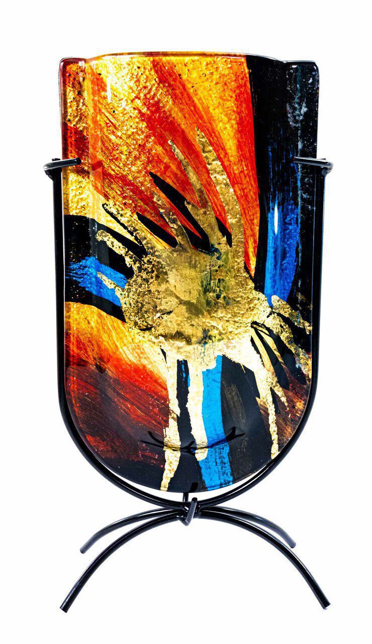 The face of the vase, showing the gold splatter central, with yellow, orange, and reds, coming out of center with blues on a black setting. The colors are almost astronomical.