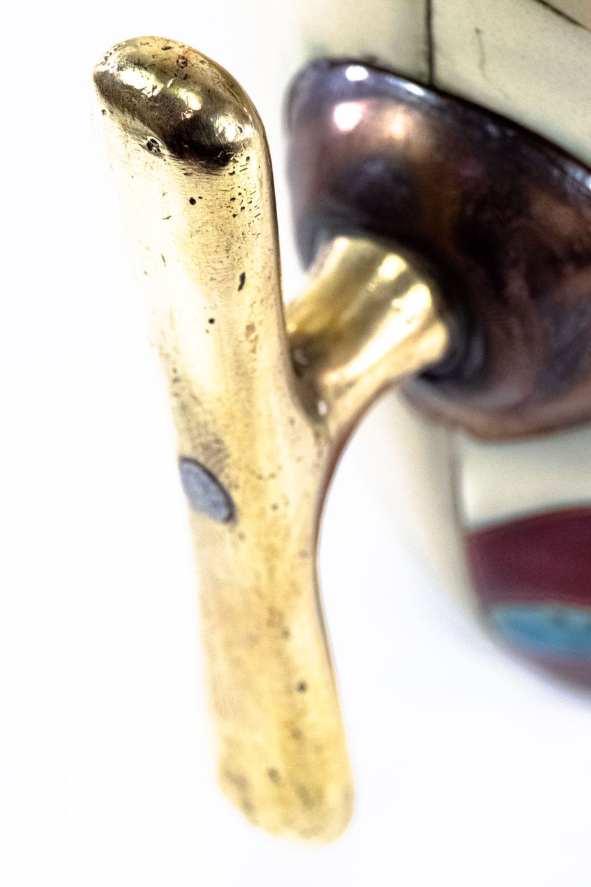 Macro image of handle of antique brass handle of option A.