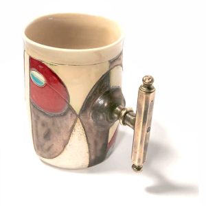 Side View of option "AD". Notice the antiqued brass handle and the design; flowing with a matching copper-brass color, featuring light a single blue symbol on each. this mug is imprinted with an "8".